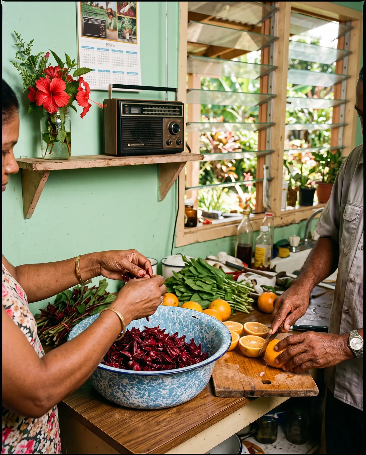 Hands cutting oranges and stripping sorrel in a sunny Trinidad kitchen
